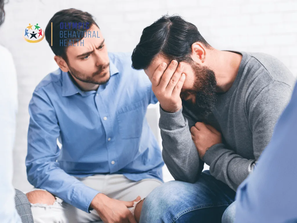 Man comforting a friend who covers his face in distress, showing how addiction strains partners, family and friends