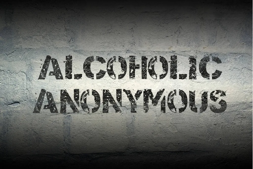 Alcoholic Anonymous stenciled on a weathered concrete wall, introducing what Alcoholics Anonymous is