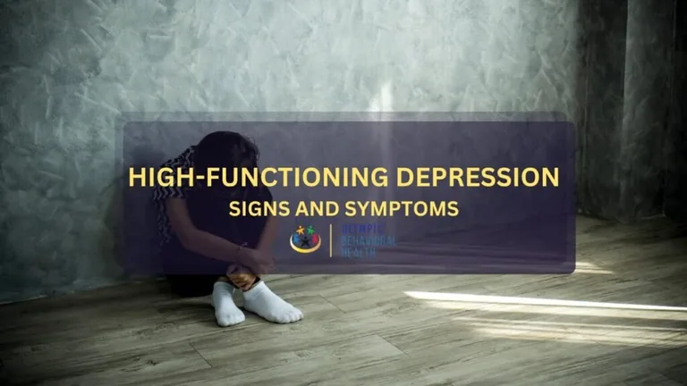 High-Functioning Depression: Signs and Symptoms featured image showing a person sitting alone against a gray wall