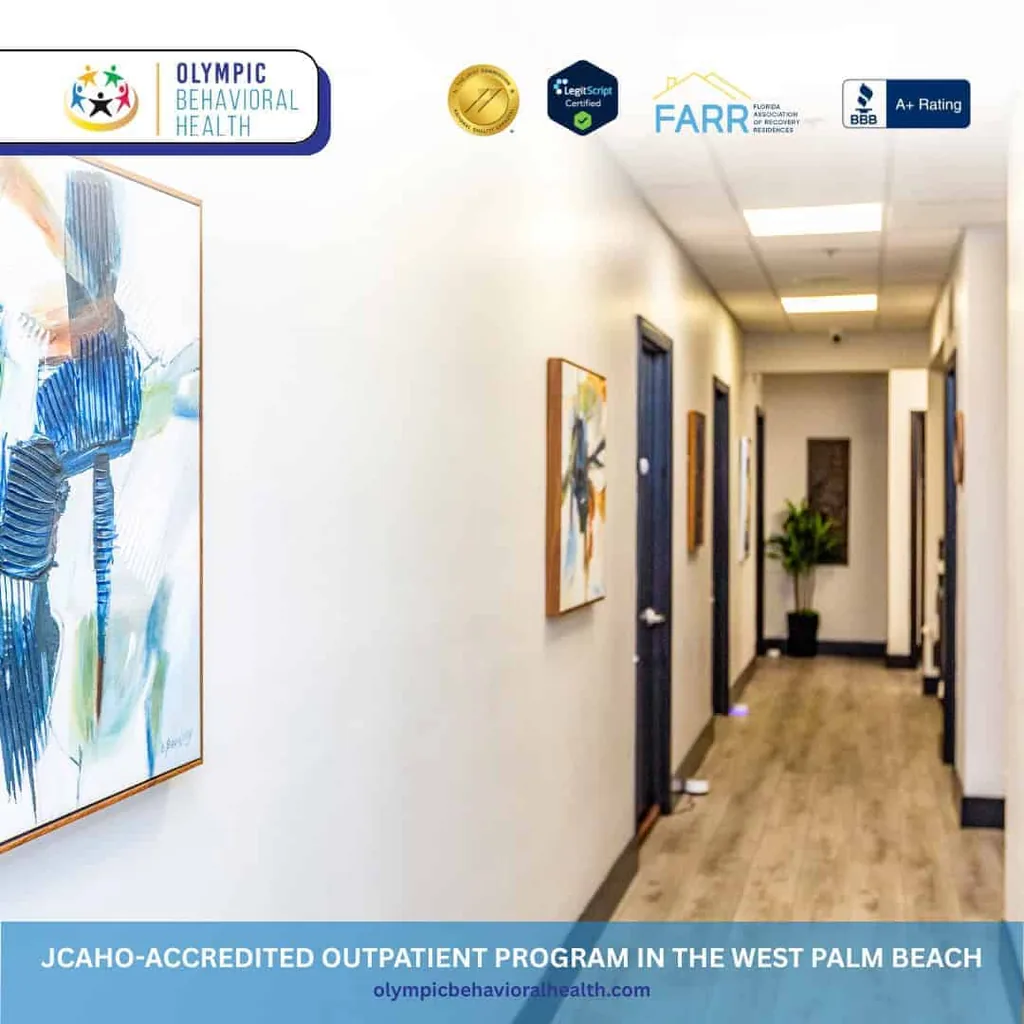 Hallway with artwork inside Olympic Behavioral Health, captioned JCAHO-accredited outpatient program in West Palm Beach