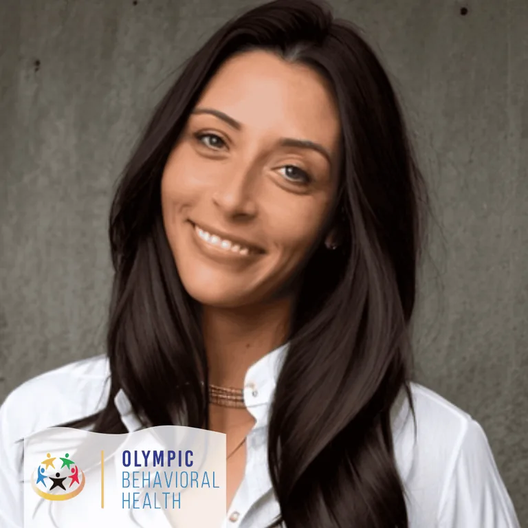 Megan Bracken, Director of Admissions at Olympic Behavioral Health, smiling with long dark hair in a white shirt