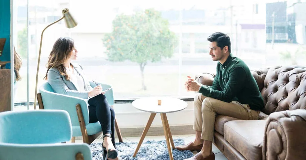 Counselor and client talking in a bright office, illustrating motivational interviewing in substance abuse treatment