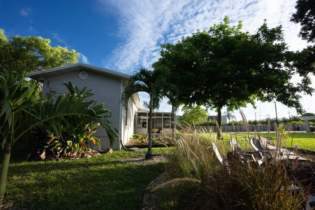 Olympic Behavioral Health building and garden with ornamental grasses and lounge chairs under a bright blue sky