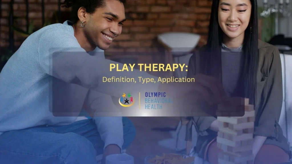 Featured image for Play Therapy: Definition, Type, Application, two young adults smiling over a block-stacking game