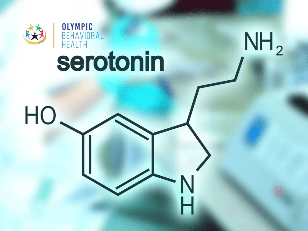 Chemical structure of serotonin labeled serotonin over a blurred lab background, explaining how serotonin is produced