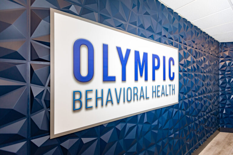 Olympic Behavioral Health sign in the lobby of the West Palm Beach outpatient treatment center